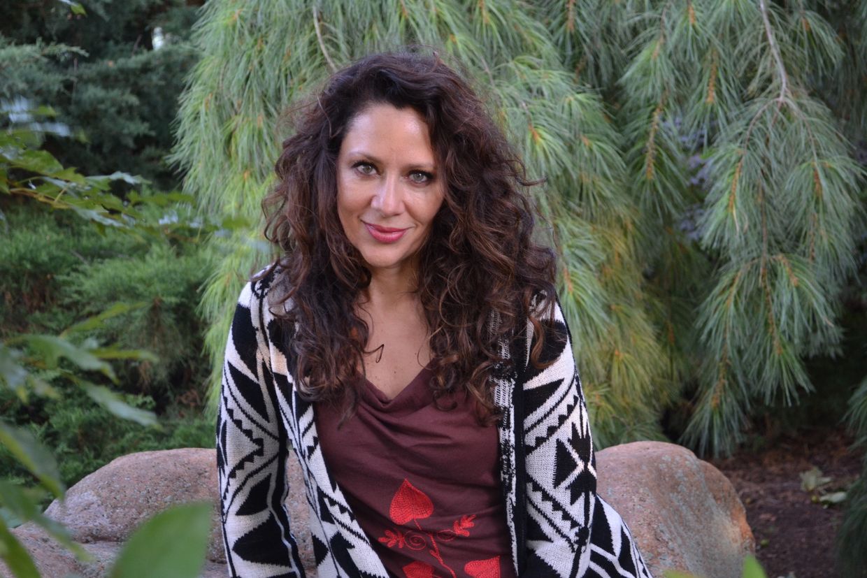 Women smiling surrounded by greenery