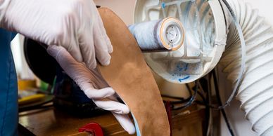 Dr. Sables builds and finishes a pair of custom foot orthotics.  Your orthotics are built in-house.