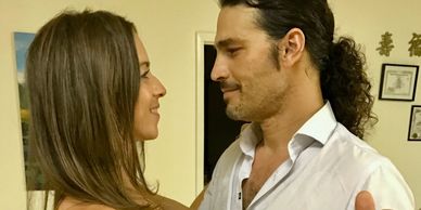 couple look lovingly at each other while dancing during their first ballroom dance lesson withGanine