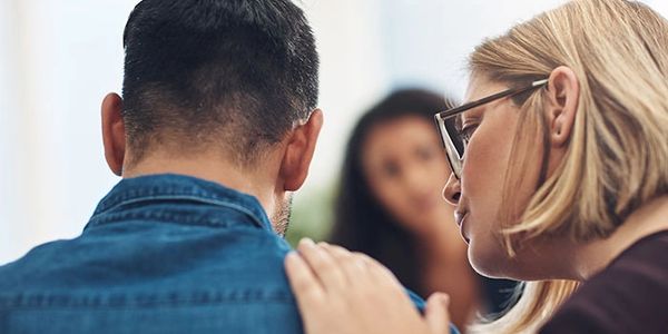 A picture of a woman trying to calm a patient
