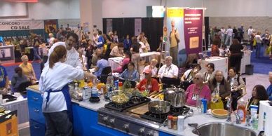 Chef Marti and Stormy Mongiello cooking liv on stage in front of 100,000 visitors.