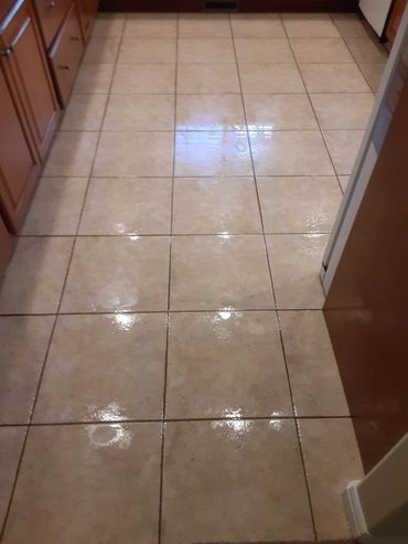 A Tile floor that is being pre-sprayed to lift soil before the extraction process