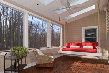 sun room with picture windows and sky lights