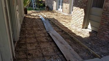 Placing wheelbarrow boards for concrete