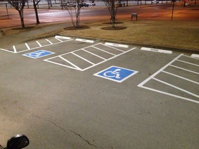 ADA-compliant parking lot striping and pavement markings after sealcoating at Grand Prairie, TX.