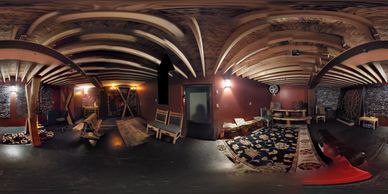 Rustic basement room with wooden beams, vintage furniture, and warm lighting.