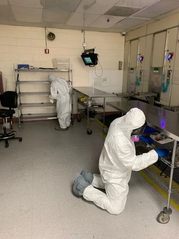 Disinfection technicians cleaning and disinfecting in medical facility.