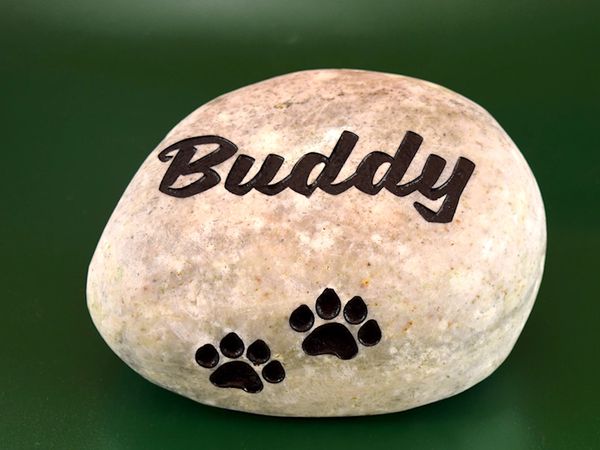 Engraved river rock pet memorial.