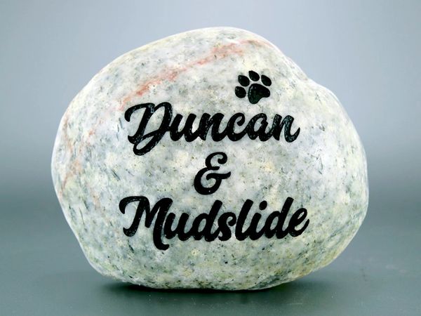 Engraved river rock pet memorial.