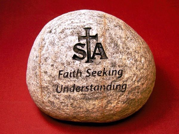 Engraved river rock with school board slogan used as a speaker's gift.