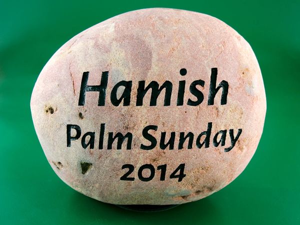 Engraved river rock pet memorial for a hamster.