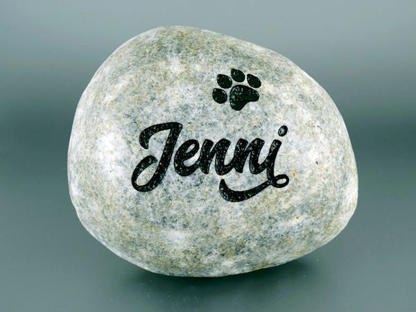 Engraved river rock pet memorial.