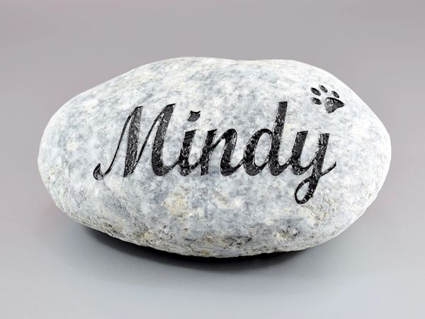 Engraved river rock pet memorial.