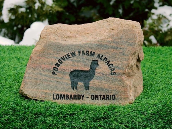 Engraved polished stone used as a farm name sign.
