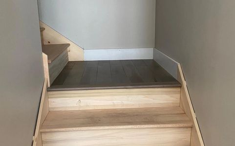 Hardwood-floor stairway of a home is clean after its construction. Residential construction cleaning