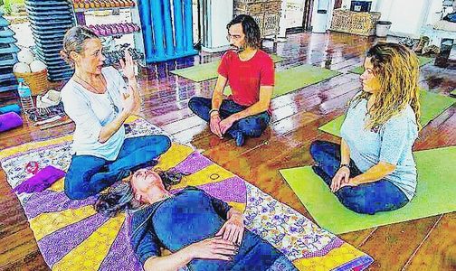 Simona teaching therapeutic massage techniques during training workshop in ibiza
