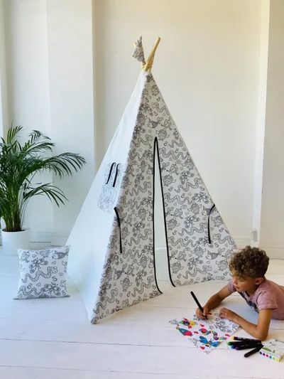 Boy playing in white kids teepee tent