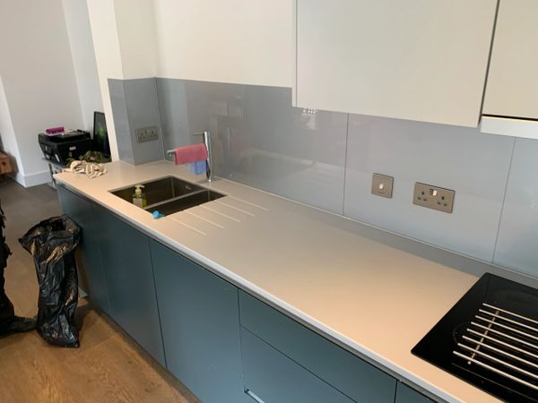 kitchen worktop and splashback fitted with new sealant , tap and electrical socket