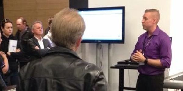 Jared Davis training a group of picture framers in a class.