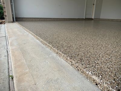 "Brown epoxy garage flooring with a glossy finish and durable coating"