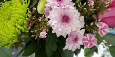 Green spider mums, lavender spray mums, hot pink roses and variegated phlox with seed eucalyptus