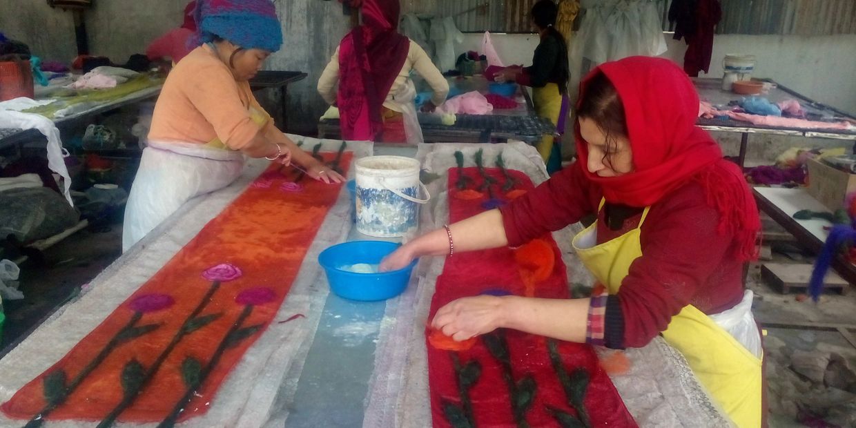 Happy women handcrafting beautiful quality durable eco friendly sustainable felts Nepal. Fair trade.