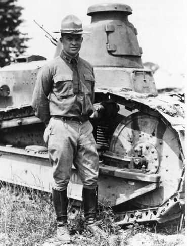 Captain Dwight D. Eisenhower of the US Army Tank Corps standing in front of an M1917 tank.