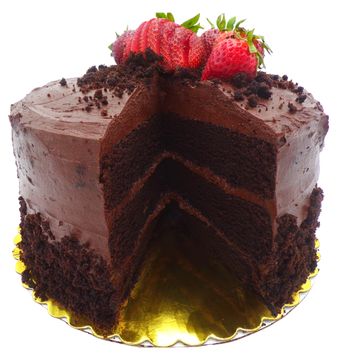 Layers of dark chocolate cake topped with chocolate buttercream frosting drizzled with chocolate syr