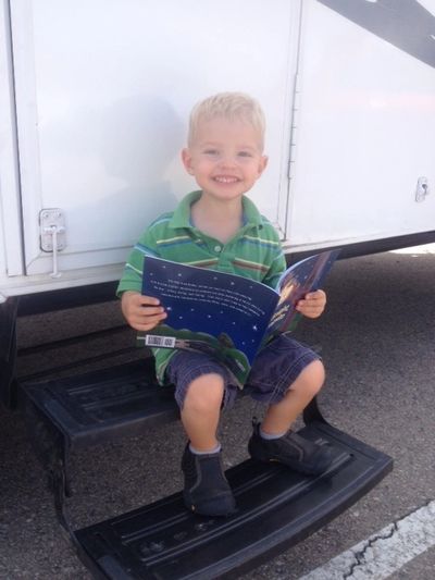 Child reading "Goodnight, Campsite" preschool camping book. Ideal for camping themed lesson plans.