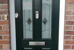 Handleless black Solid Core door with brushed steel Ignot knocker and finger pull fitted in Clowne.