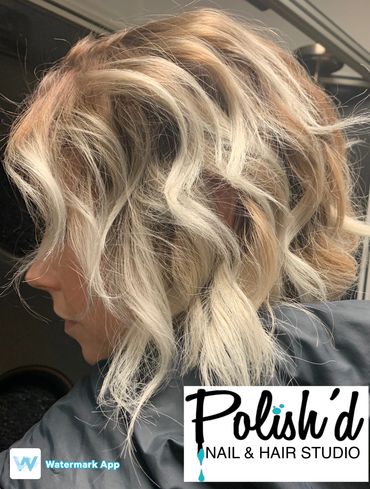 Blonde wavy bob hairstyle with highlights.