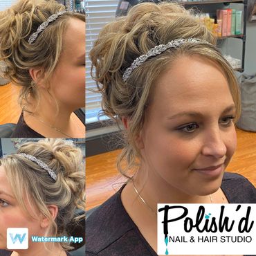 Woman with an elegant updo hairstyle and a decorative headband.