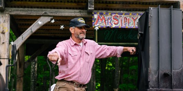 MrSippy tending the fire on the smoker