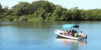 Birders on a motor boat in a river