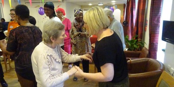 A woman from a bereavement charity helping another woman celebrate a special occasion.