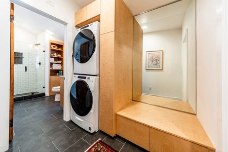 Whirlpool steam washer & dryer in the laundry are leading into the bathroom