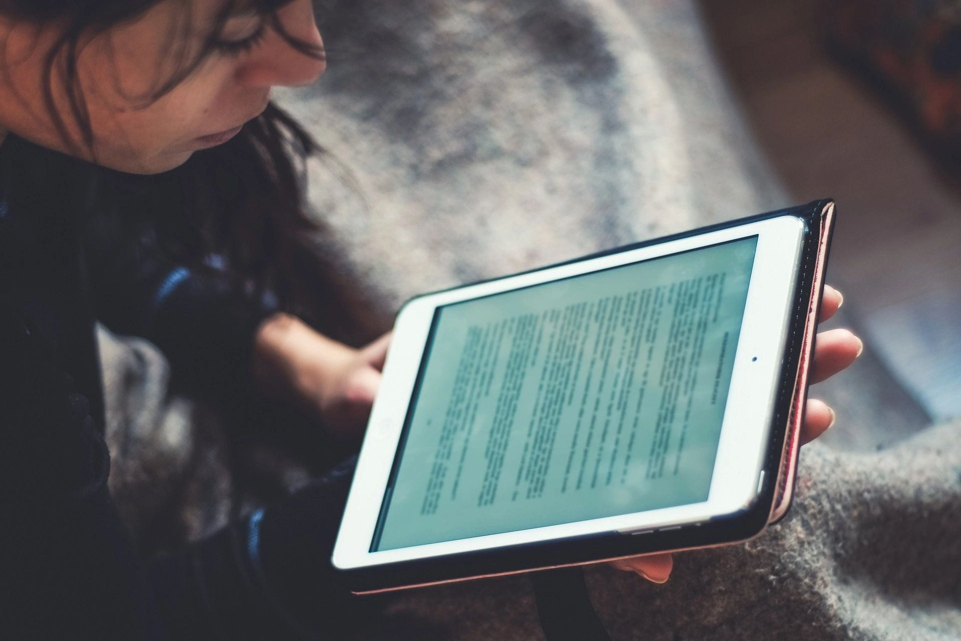 a lady reading on her iPad