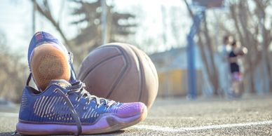 Reboot Sport Defender. Get back on the field. Image of shoes and basketball on outdoor court.