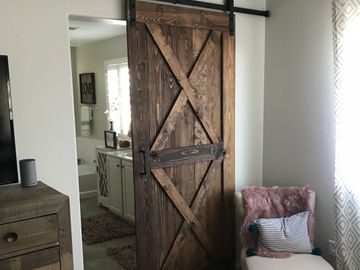 Double X barn door to close off master bathroom. Stained dark walnut.