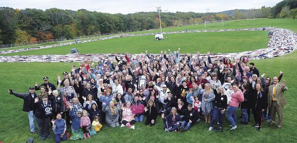 A group of people in front of the world’s longest bra chain