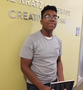 A boy standing and giving pause for picture