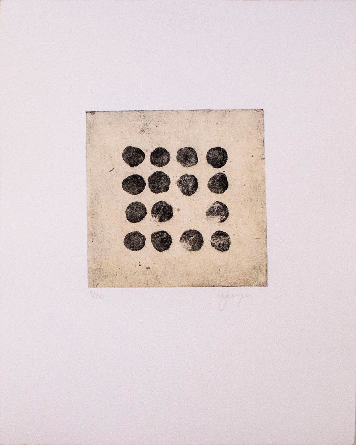 Square made up of black circles on a tan background