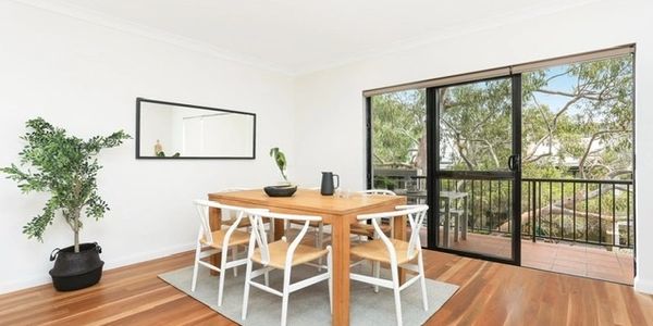 styled for sale. dining room table on wooden floors