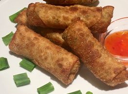 Homemade egg rolls served with sweet and sour sauce.