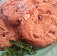 Nutty Chocolate chip cookies served on a plate and garnished with fresh mint.