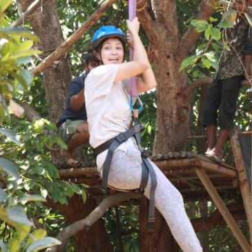 Ziplining in a forest adventure.