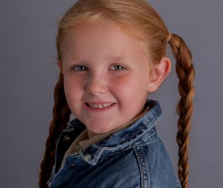redhaired girl with braided pigtails
