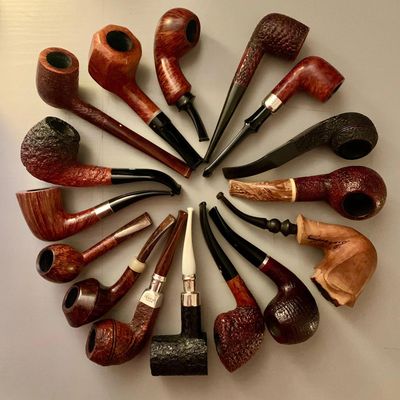 A selection of briar tobacco pipes showing a range of styles and finish