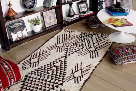Handmade Moroccan Beni Ourain wool rug with intricate pattern of Berber motifs and ornate diamonds.