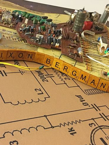 Found scrabble letters spell the artist;s signature